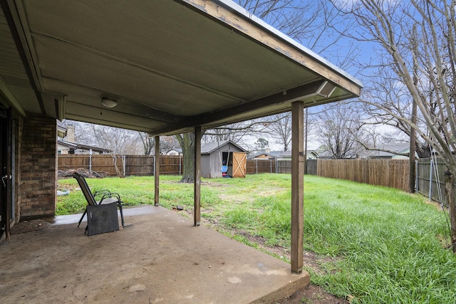 view of patio / terrace featuring an outdoor structure, a fenced backyard, and a storage unit