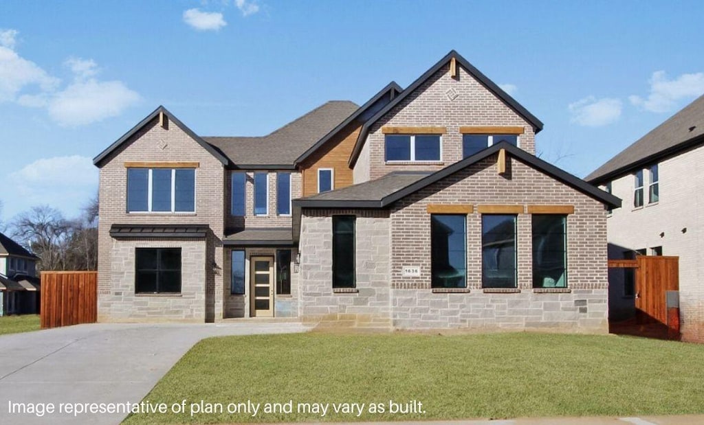 view of front facade featuring stone siding, brick siding, a front yard, and fence