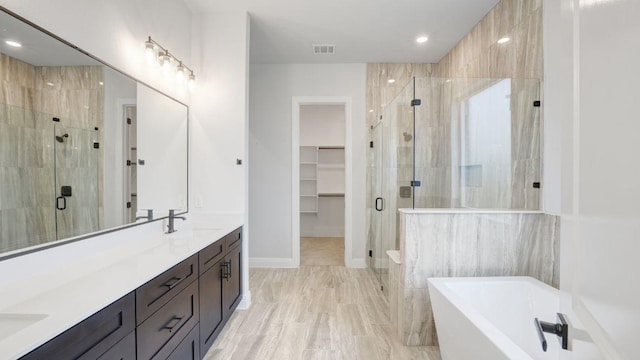 1636 Keneipp Rd, Carrollton, TX 75006 - full bathroom featuring a sink, a stall shower, a soaking tub, double vanity, and visible vents