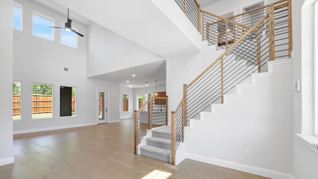 1636 Keneipp Rd, Carrollton, TX 75006 - foyer with a high ceiling, a ceiling fan, wood finished floors, and stairs