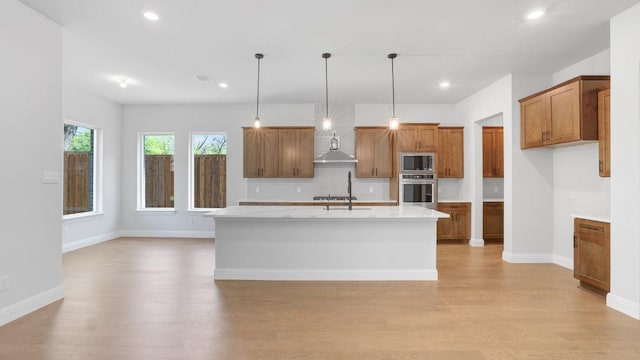 1636 Keneipp Rd, Carrollton, TX 75006 - kitchen featuring tasteful backsplash, brown cabinets, light wood-type flooring, appliances with stainless steel finishes, and recessed lighting