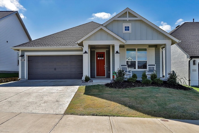 view of front facade with a porch, an attached garage, concrete driveway, a front lawn, and board and batten siding