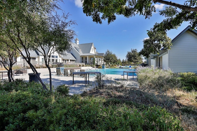 pool with fence and a patio