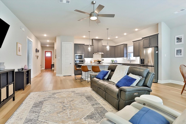 living area featuring light wood-style floors, visible vents, and recessed lighting