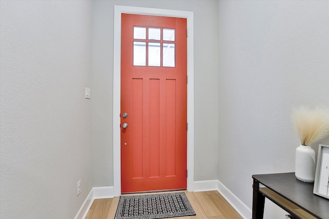 interior space featuring baseboards and light wood-style floors