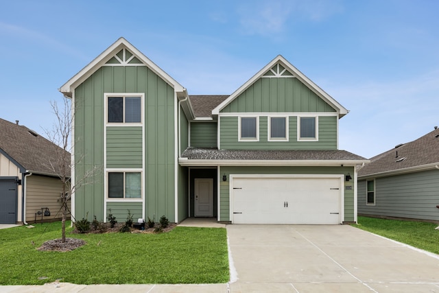 view of front of house with board and batten siding, a front yard, driveway, and an attached garage