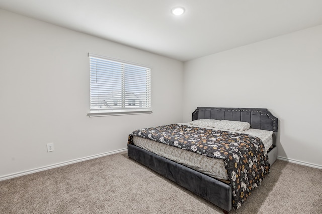 bedroom with carpet flooring and baseboards