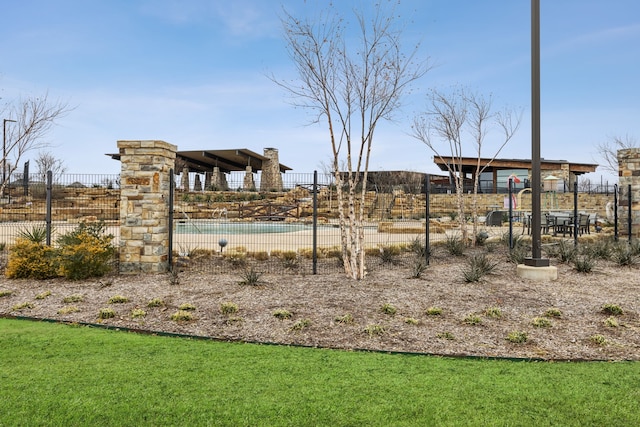 view of yard with fence and a community pool