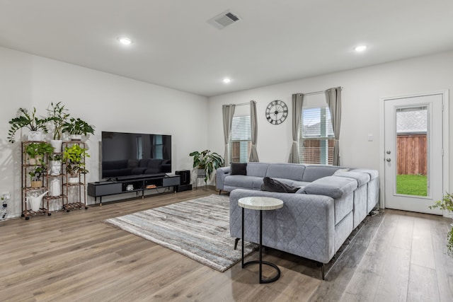 living room featuring wood finished floors, visible vents, and recessed lighting