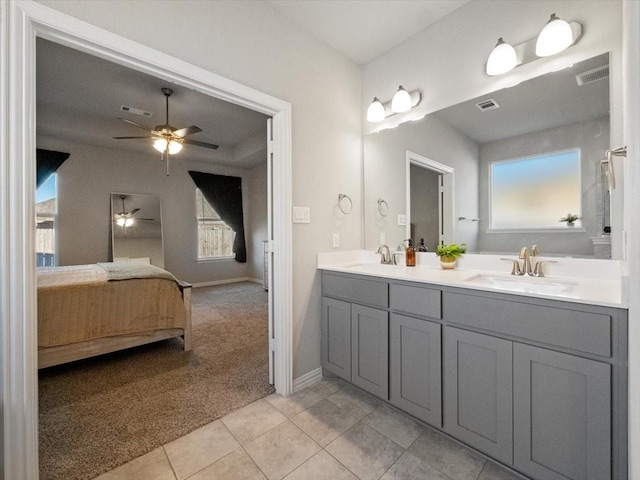 full bath featuring double vanity, tile patterned flooring, connected bathroom, and a sink