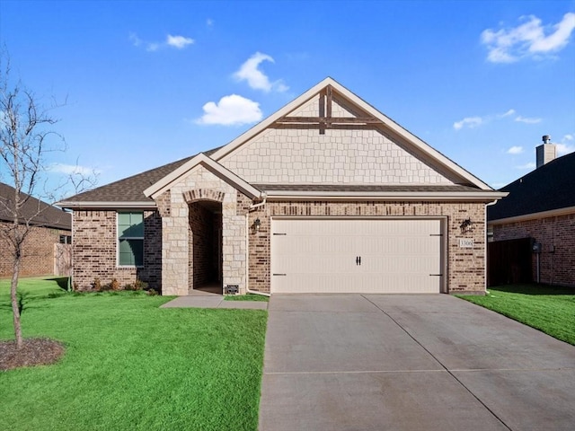 view of front facade with a garage, driveway, a front lawn, and brick siding