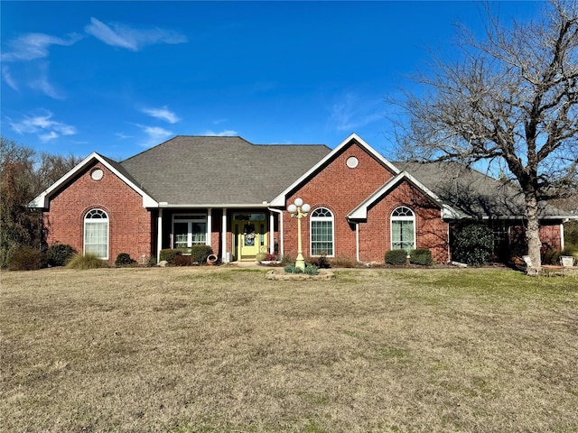 ranch-style house featuring brick siding and a front lawn