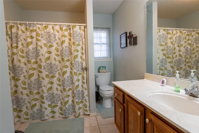 full bathroom featuring a textured ceiling, vanity, tile patterned flooring, and toilet