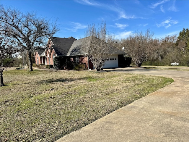 view of property exterior featuring a garage, a lawn, concrete driveway, and brick siding