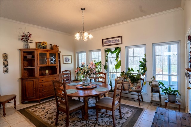 dining room featuring a healthy amount of sunlight, light tile patterned floors, ornamental molding, and a notable chandelier