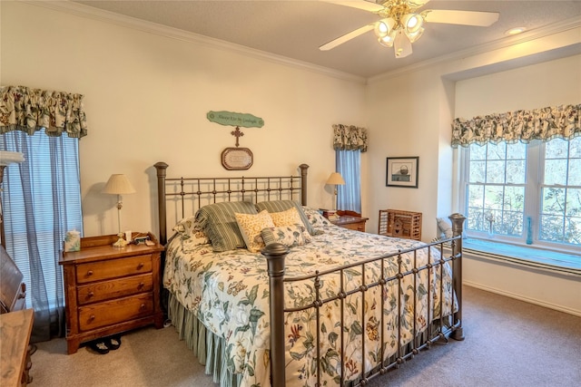 carpeted bedroom featuring ornamental molding, baseboards, and a ceiling fan