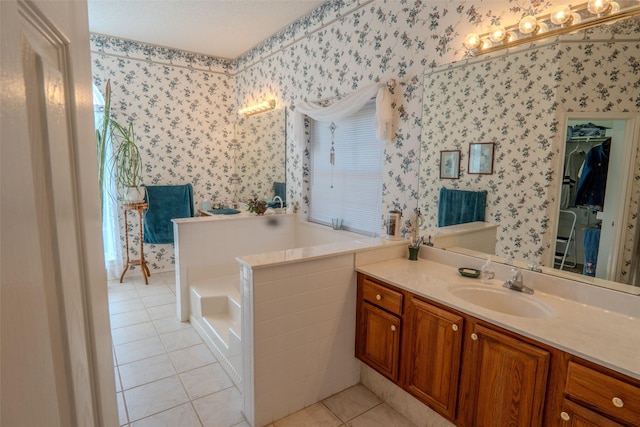 bathroom with tile patterned flooring, a walk in closet, vanity, and wallpapered walls