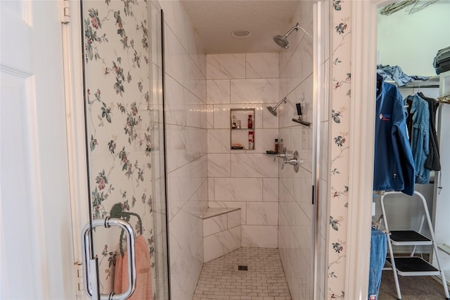 full bathroom featuring a spacious closet and a stall shower