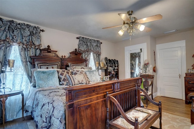 bedroom with visible vents, ceiling fan, and light wood finished floors