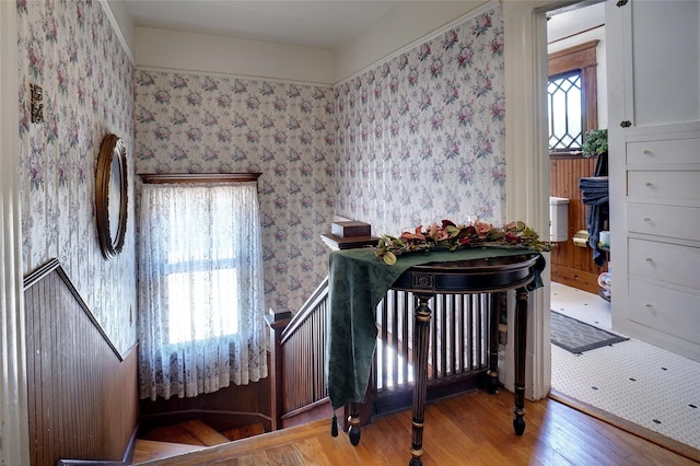 bedroom featuring light wood-type flooring and wallpapered walls