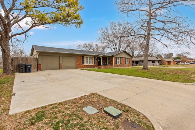 view of front of property with a garage, brick siding, fence, concrete driveway, and a front yard