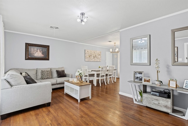 living area with baseboards, visible vents, ornamental molding, and dark wood-style flooring