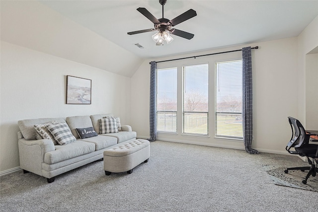 living area with carpet floors, lofted ceiling, visible vents, a ceiling fan, and baseboards