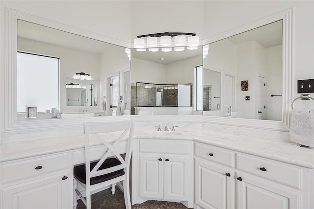 bathroom with a stall shower and vanity