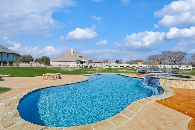 view of swimming pool featuring a fire pit, fence, a pool with connected hot tub, a yard, and a patio area