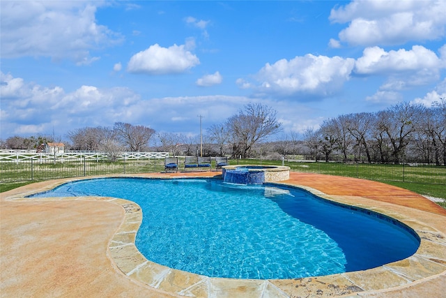 view of pool featuring a patio, fence, and a pool with connected hot tub