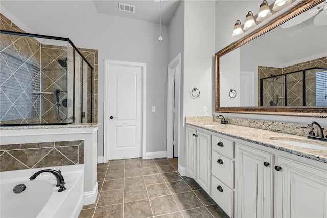 bathroom with a shower stall, a sink, visible vents, and tile patterned floors