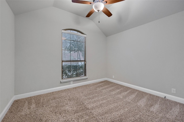 empty room with lofted ceiling, carpet, baseboards, and ceiling fan