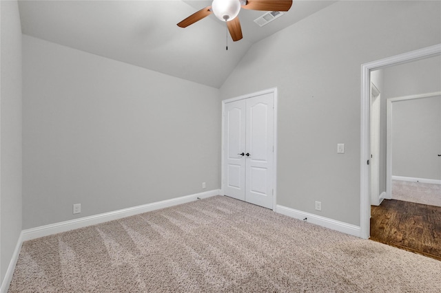 unfurnished bedroom with lofted ceiling, baseboards, visible vents, and a closet