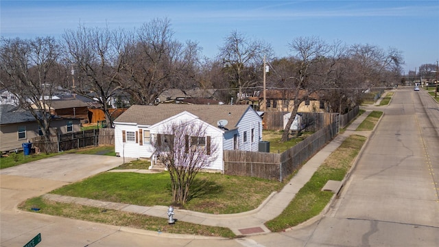 bungalow-style house featuring a front lawn and a fenced front yard