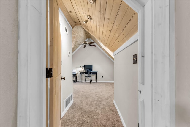 hallway featuring carpet, visible vents, baseboards, lofted ceiling, and wooden ceiling