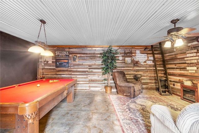 playroom featuring wooden walls, billiards, and a ceiling fan