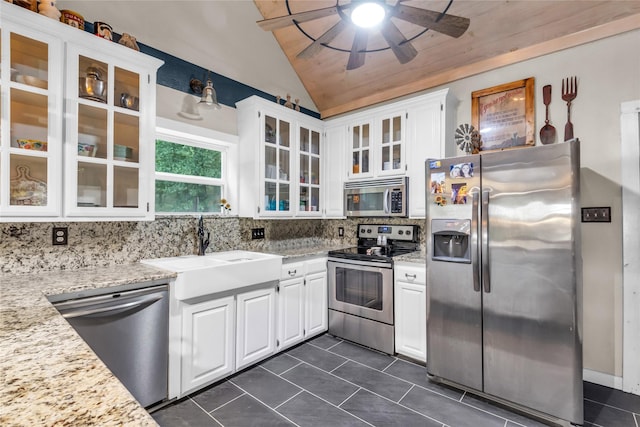 kitchen featuring a sink, white cabinetry, stainless steel appliances, decorative backsplash, and ceiling fan