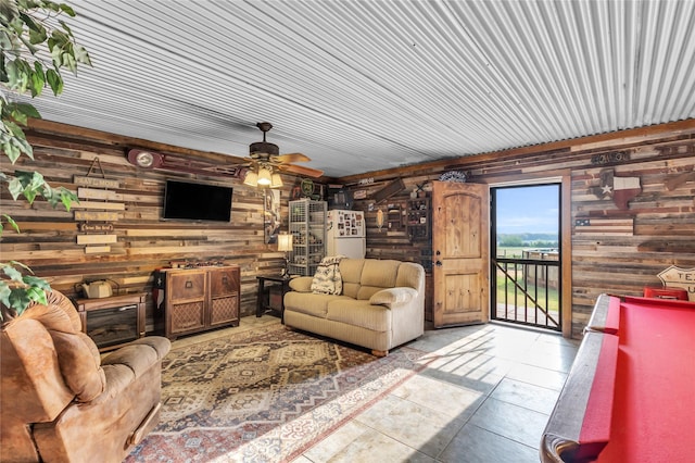 tiled living area with ceiling fan
