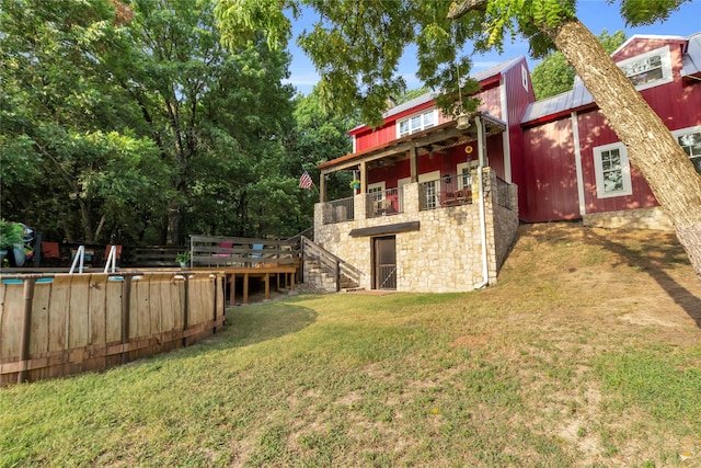 view of yard with a balcony and stairway