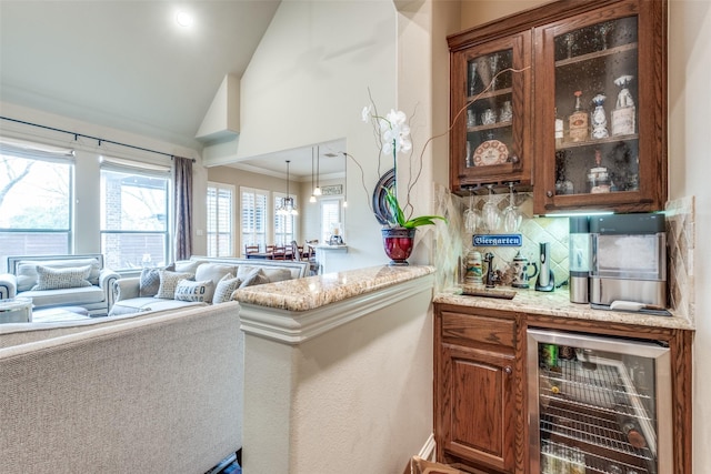 bar featuring tasteful backsplash, wine cooler, plenty of natural light, and a bar