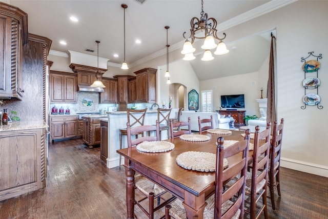 dining space featuring crown molding, arched walkways, visible vents, and dark wood finished floors