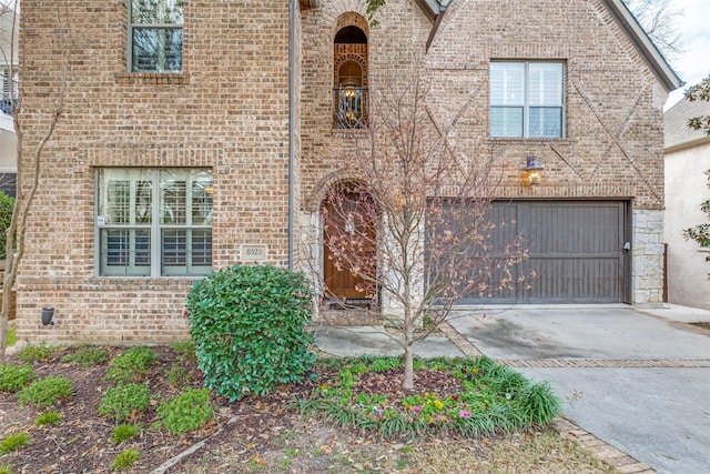 view of front facade with concrete driveway and brick siding