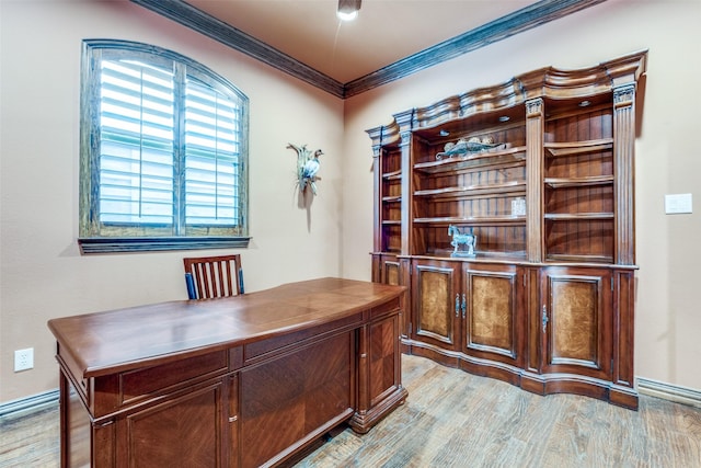 home office with ornamental molding and light wood-style floors