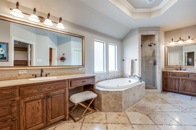 bathroom with a tray ceiling, a garden tub, ornamental molding, a shower stall, and vanity