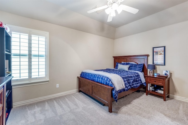 bedroom featuring light colored carpet, ceiling fan, and baseboards