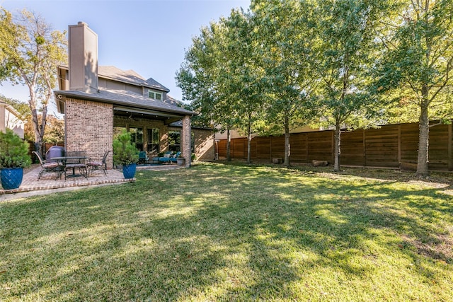 view of yard with a patio area and a fenced backyard