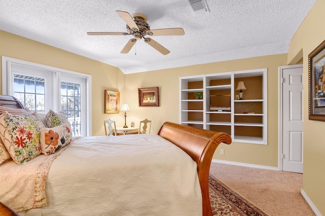 carpeted bedroom featuring a ceiling fan, visible vents, a textured ceiling, and baseboards