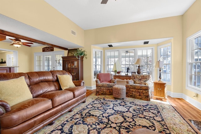 living area with visible vents, french doors, wood finished floors, and a ceiling fan