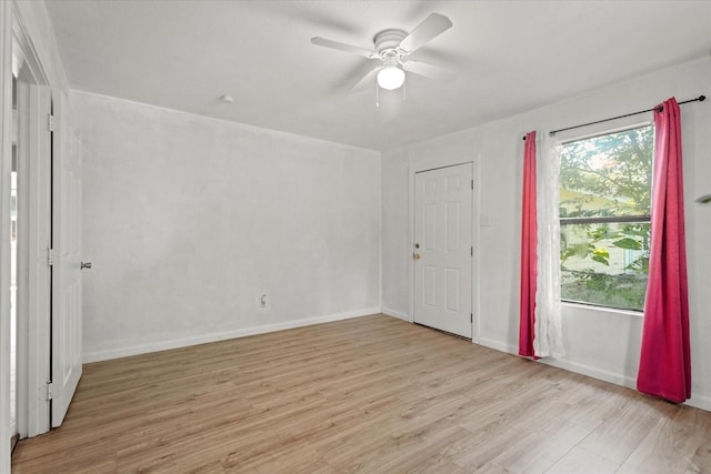 unfurnished bedroom featuring light wood-type flooring, ceiling fan, and baseboards