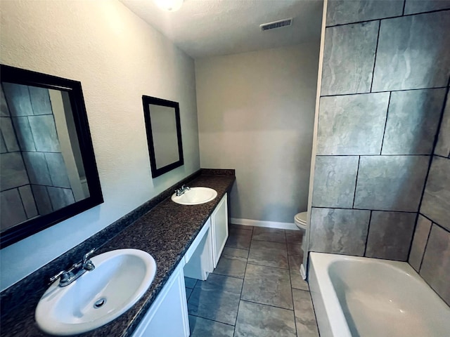 bathroom with visible vents, a sink, toilet, and double vanity